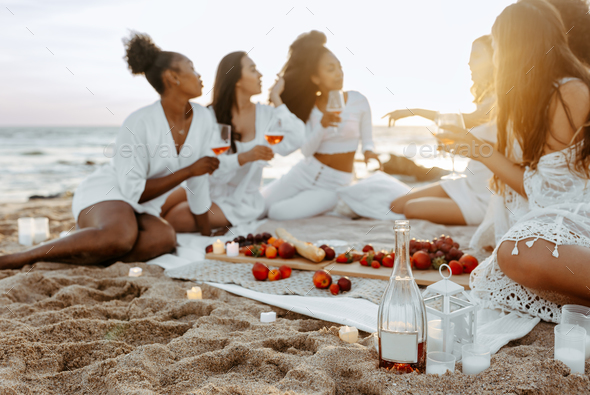 Young woman enjoying at summer beach party. Young female friends