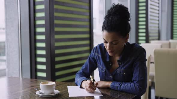 Young African American Woman Dreamily Thinking About Something and Then Squeaking on a Piece of alt