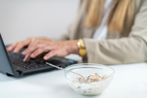 The perfect balance of work and wellness as a woman embraces healthy eating at her workplace