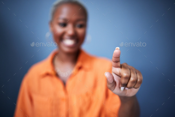 Finger, security and black woman user in studio on blue background for internet browsing or access