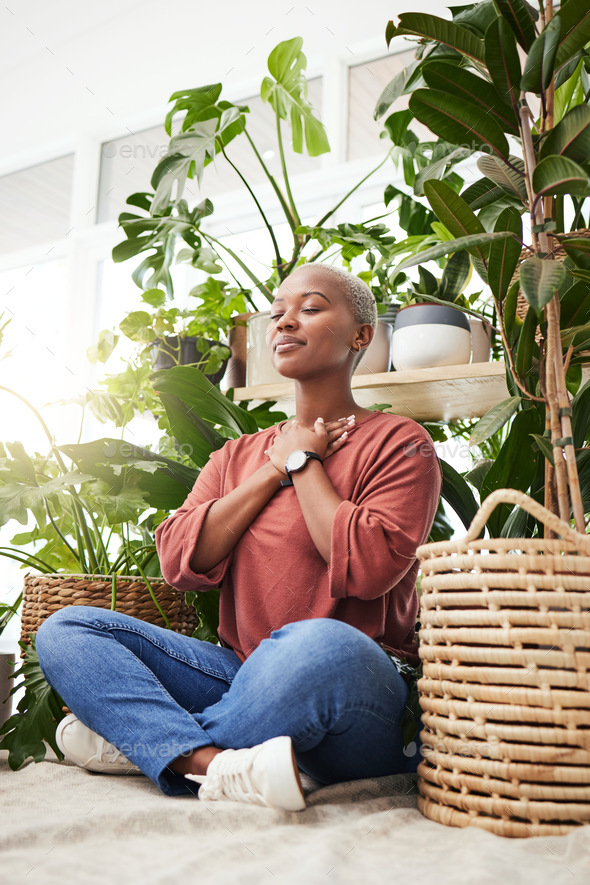 Wellness, peace and woman breathing by plants for meditation in a natural greenhouse. Breathe