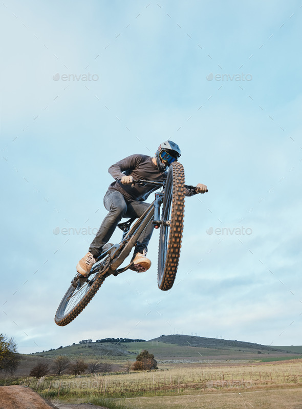 Cycling, fitness and man with bicycle jump for extreme sports, energy and adrenaline in nature. Jum