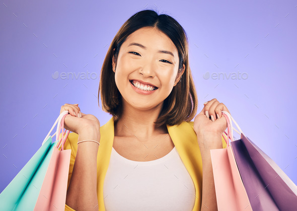 Happy woman, portrait and shopping bag with retail and fashion, commerce and sale on purple backgro