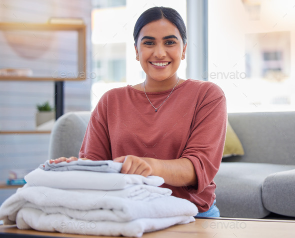 Cleaning, happy and laundry with portrait of woman in living room for housekeeping service, clothes