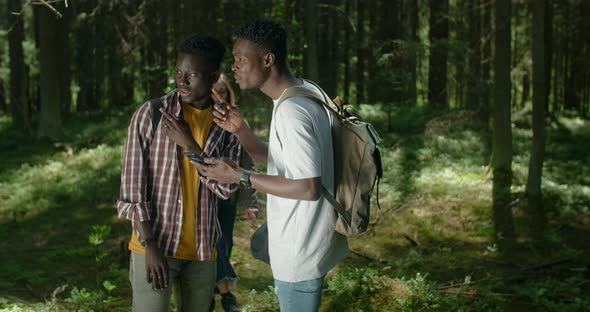 Young Black Friends are Hiking and Searching the Path By Map App in Smartphone Hiking in Forest 60p