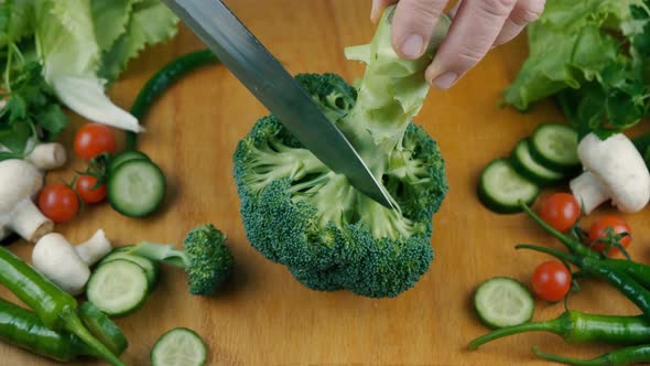 Close Up Knife Cutting Fresh Green Broccoli