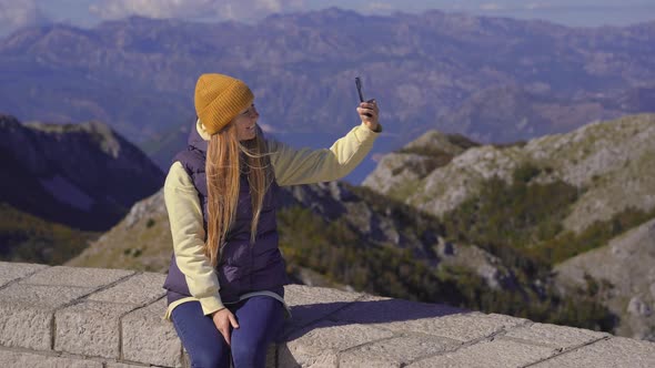 A Young Woman Traveler Visits the View Point on the Top of the Lovcen Mountain alt