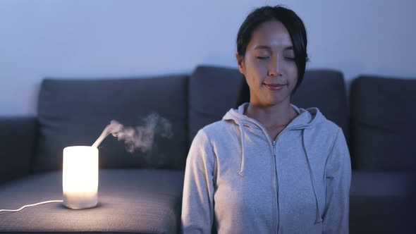 Woman Sitting at Home and Meditating 