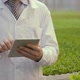 Laboratory Assistant Stands with Tablet in Hands in Premise of Agro-industrial Complex - VideoHive Item for Sale