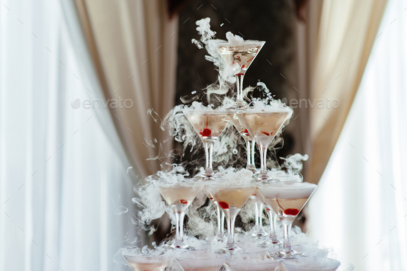 Champagne glass pyramid. Pyramid of glasses of wine, champagne, tower of champagne on wedding