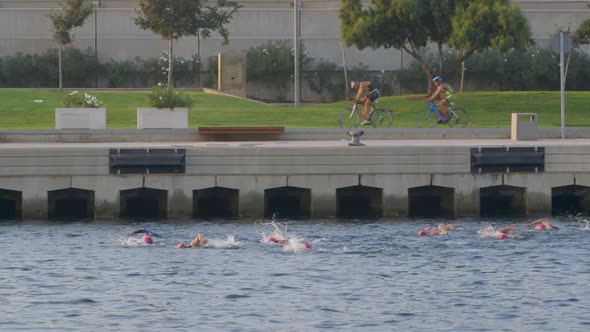 Triathletes Cycling and Swimming
