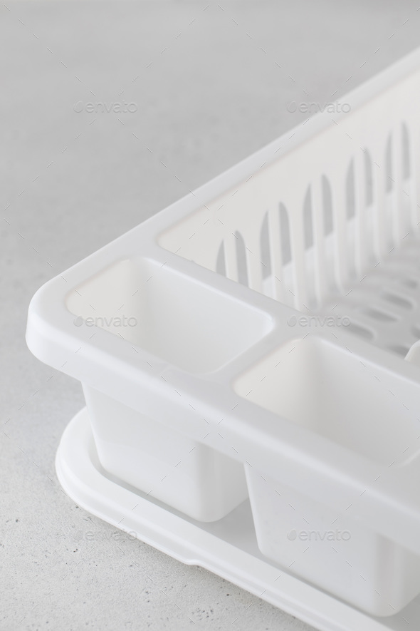 Plastic white dish dryer. Accessories for the kitchen, washing dishes. Close up.