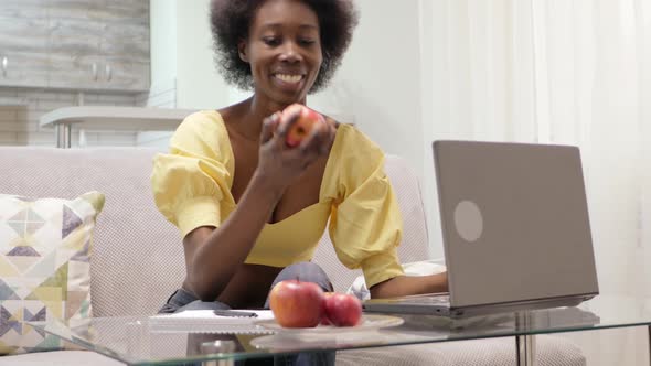 African Black American Woman Sits in Front of Laptop Freelance Work at Home