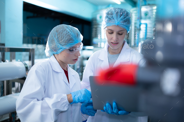 Two young female scientists working with tablet computer in drinking water plant - Stock Photo - Images