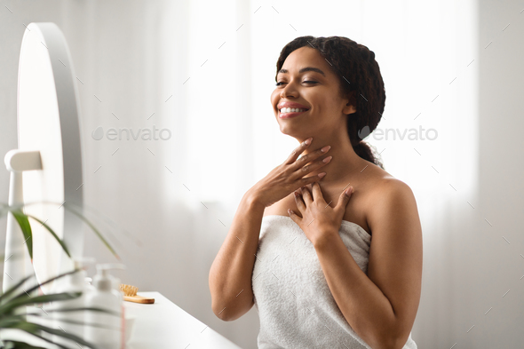 Neck Wrinkles Treatment. Smiling Black Woman Touching Her Soft Smooth Skin