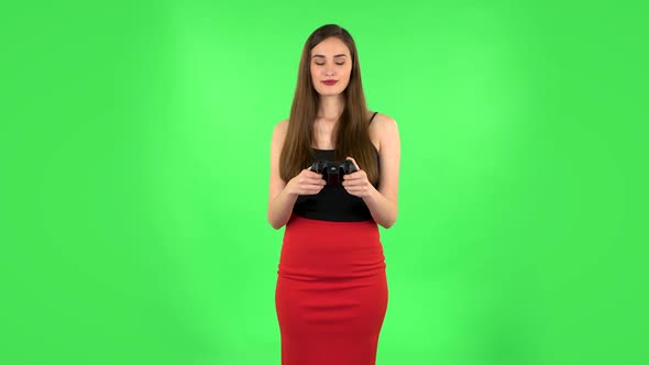 Girl Playing a Video Game Using Wireless Controller. Green Screen alt