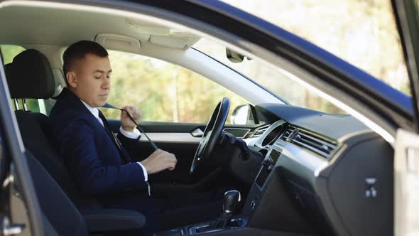 Male in Formal Clothing Locking Safe Belt Before Starting to Drive Modern Car