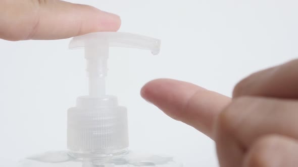 Slow motion  extracting sanitizer gel from container close-up footage alt