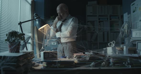 Depressed businessman in the abandoned office alt