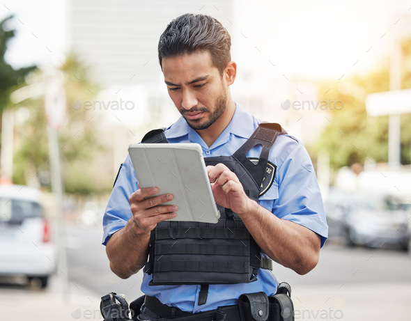 Police, tablet and patrol with a man officer outdoor on the street, using the internet to search du