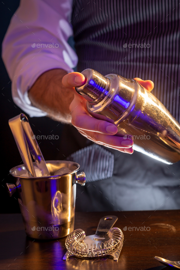 Barman with shaker featuring bartender, shaker, and cocktail