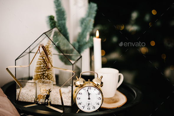 Christmas composition. Candle, cup coffee, vintage gold clock, metal gold candle holder in the shape - Stock Photo - Images