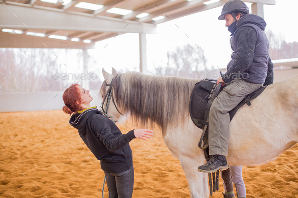 Horse therapy. therapeutic equestrian therapist assistance help patient with disability.