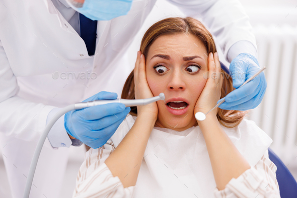 Woman afraid at dentist office