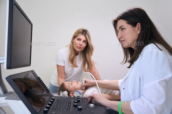 Daughter with her mother for ultrasound of the thyroid gland