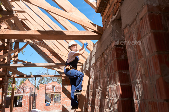 Woman general contractor checking strength of supporting beams