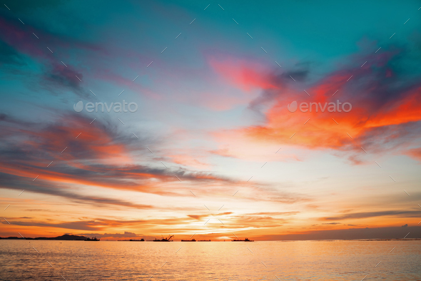 Sunset Colorful sunset at the sea. Romantic Sunet go down, blue and orange clouds flow in sky.