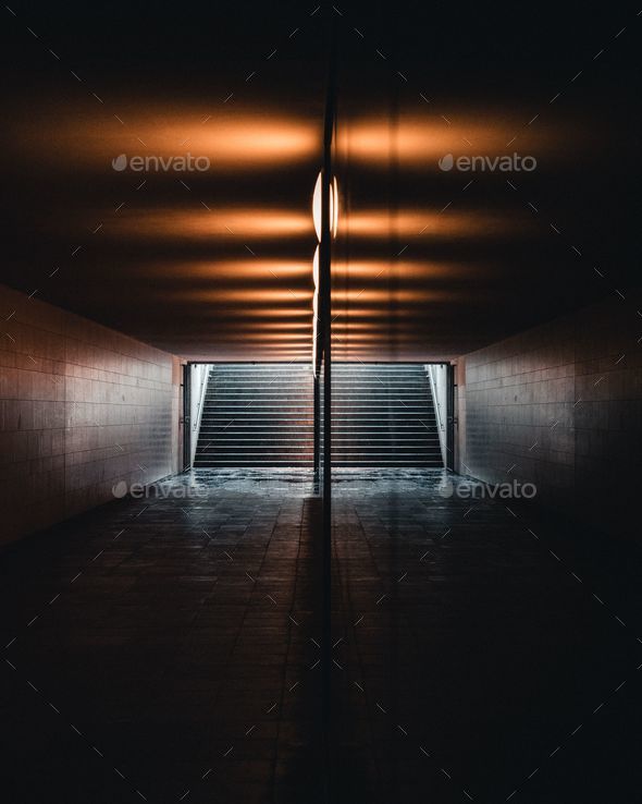 Underground passageway with dim lighting and stairs leading to the street