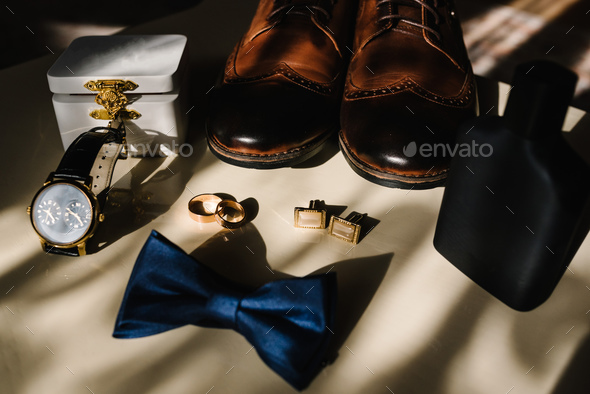 Men's accessories: watches, cufflinks, bow tie, perfume, shoes, rings on a  light background. Close Stock Photo by kurinchukolha