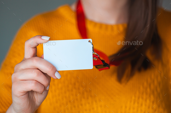 Woman holding badge name tag, with blank space mock up