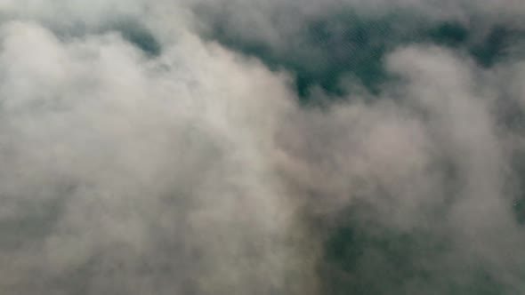 Drone Over Clouds And Mist Covering Fjord alt