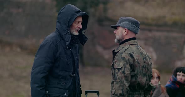 Angry Military Man Arguing With Senior Male Refugee alt