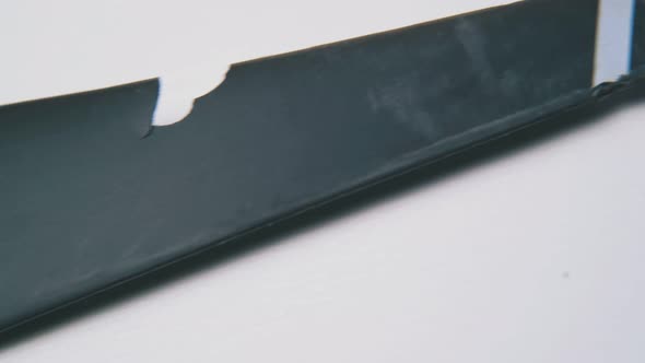 Broken Black Propeller of Drone on White Background Macro alt