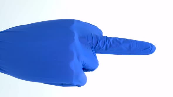 Vertical orientation video: Hand dummy of a medical gloved. Wooden hand of a blue latex gloved