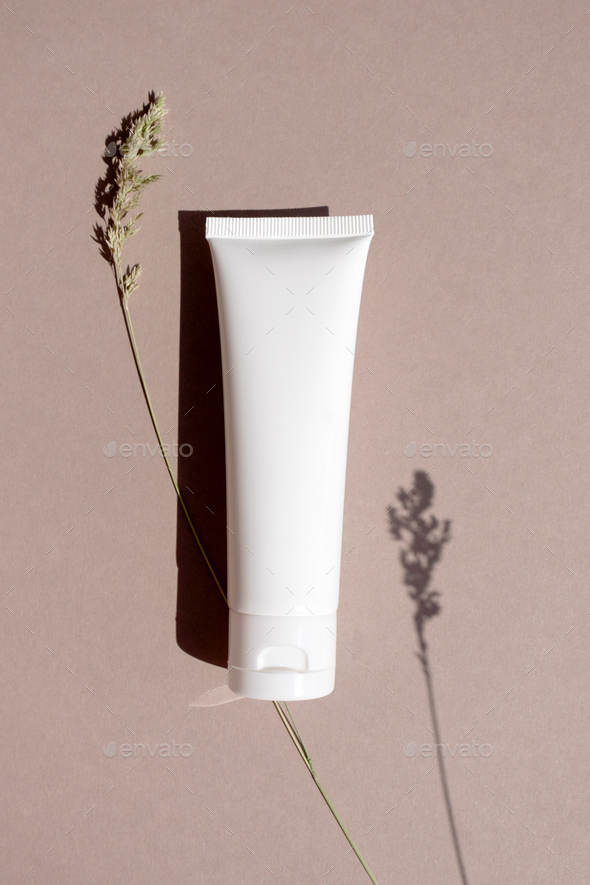 Cream, moisturizer, lotion, facial cleanser or shampoo on beige brown background