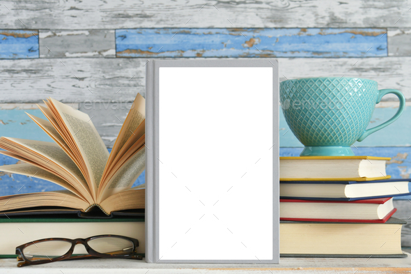 Summer book cover mock up, plain book against stacks of books with mug and glasses