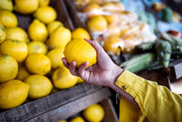 Faceless Person Buying Lemons Closeup