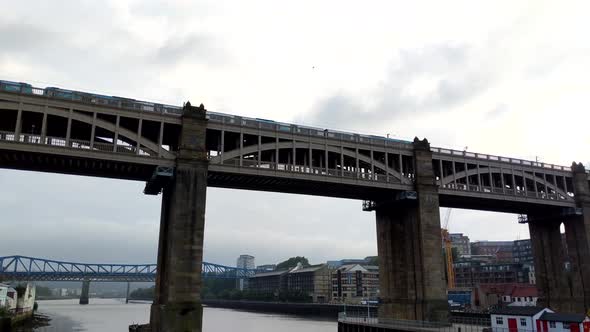 Pan Video of Train passing over the Tyne River over the High level bridge in Newcastle, England alt