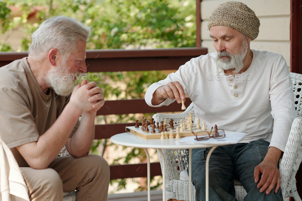 A group of chess pieces sitting on top of a chess board photo