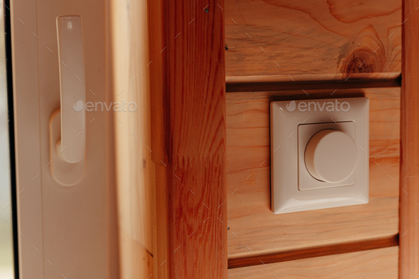 Close up electrical dimmer switch light for adjustable brightness control in wooden house