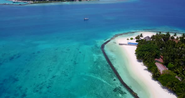 Wide angle birds eye travel shot of a sandy white paradise beach and aqua blue water background in b alt