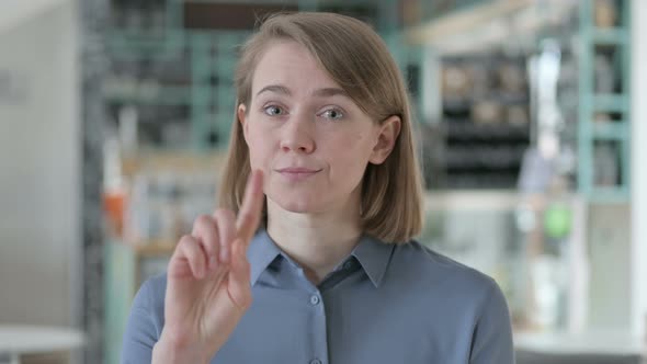 Portrait of Young Woman Showing No Sign By Finger alt