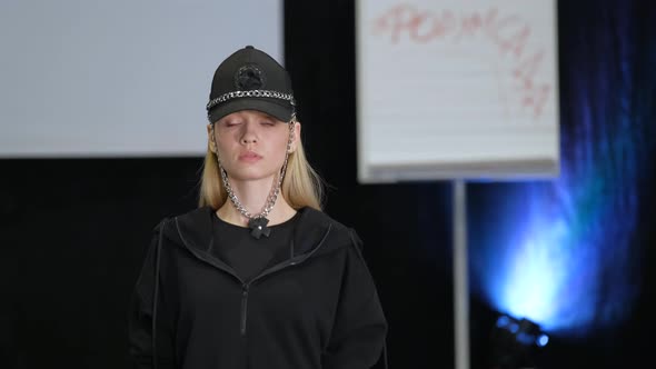 Fashion Woman in Black Hoodie Moving on Vogue Podium Stage