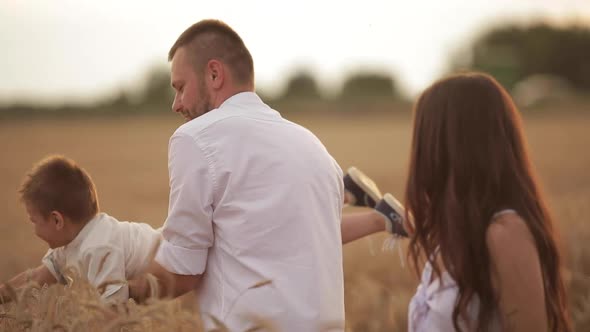 Father Playing with His Son in Wheat Field.