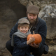 boy without front teeth and his dad with a long beard  are sitting with a pumpkin - PhotoDune Item for Sale