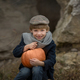boy blindin without front teeth in vintage clothes is sitting with a pumpkin - PhotoDune Item for Sale